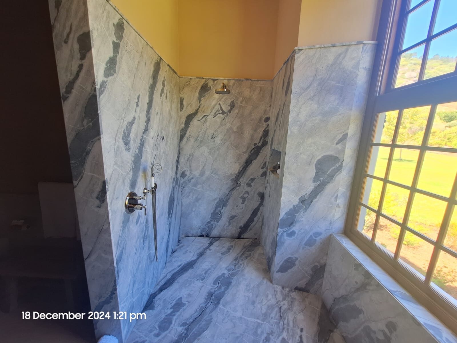 Marble shower with a window