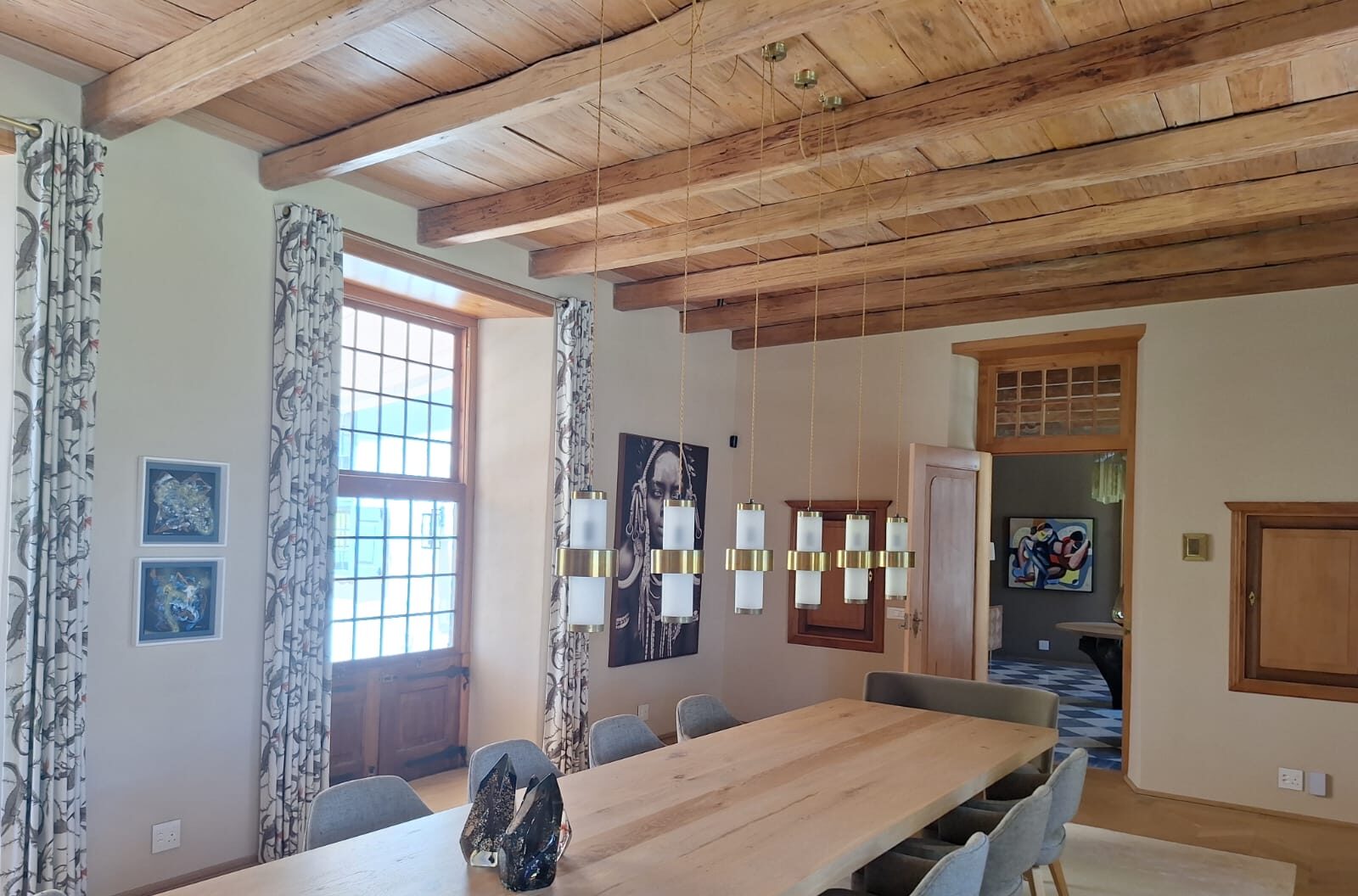 Dining room with a long table under beams