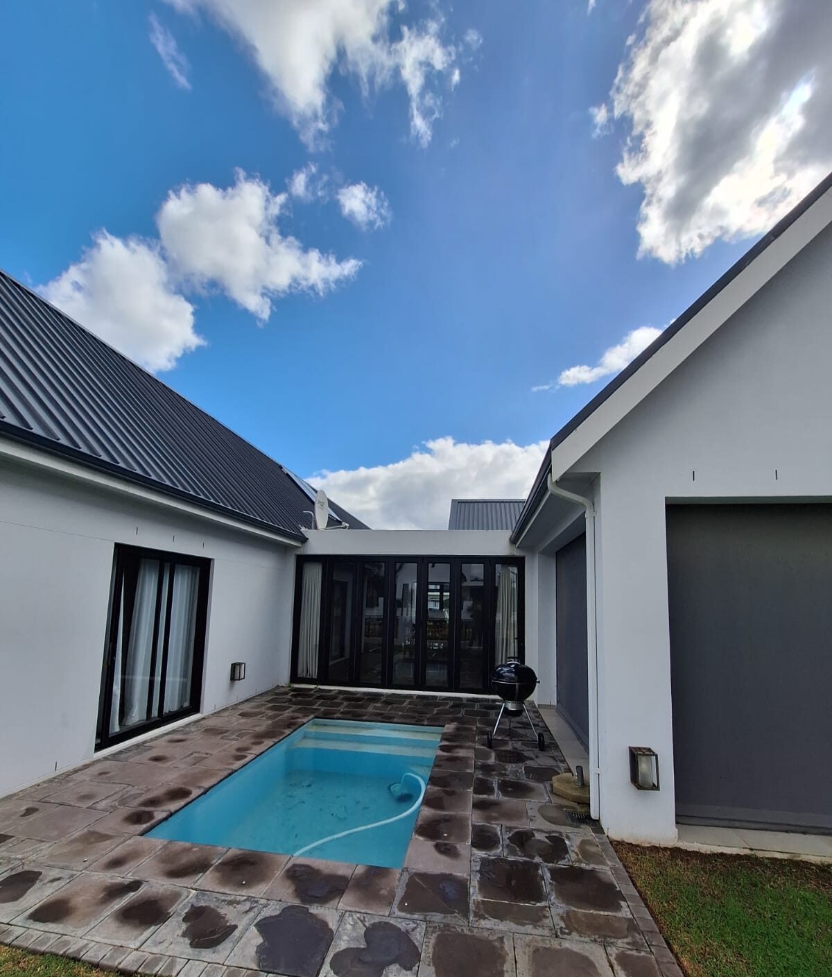 Modern pool courtyard between two wings