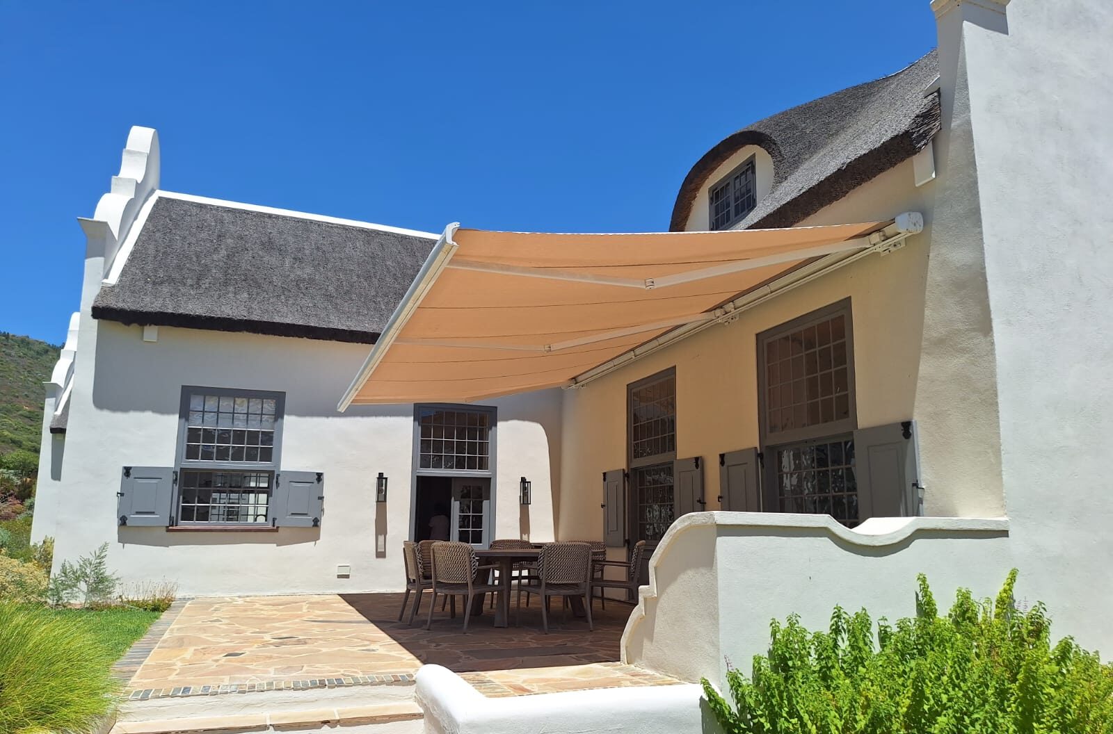 Estate patio with a shade sail