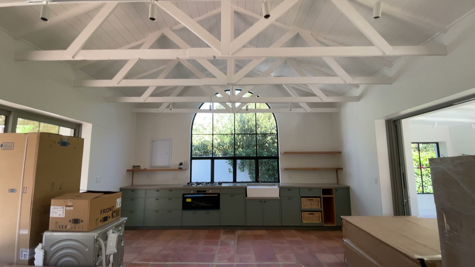 Renovated kitchen with an arched steel window