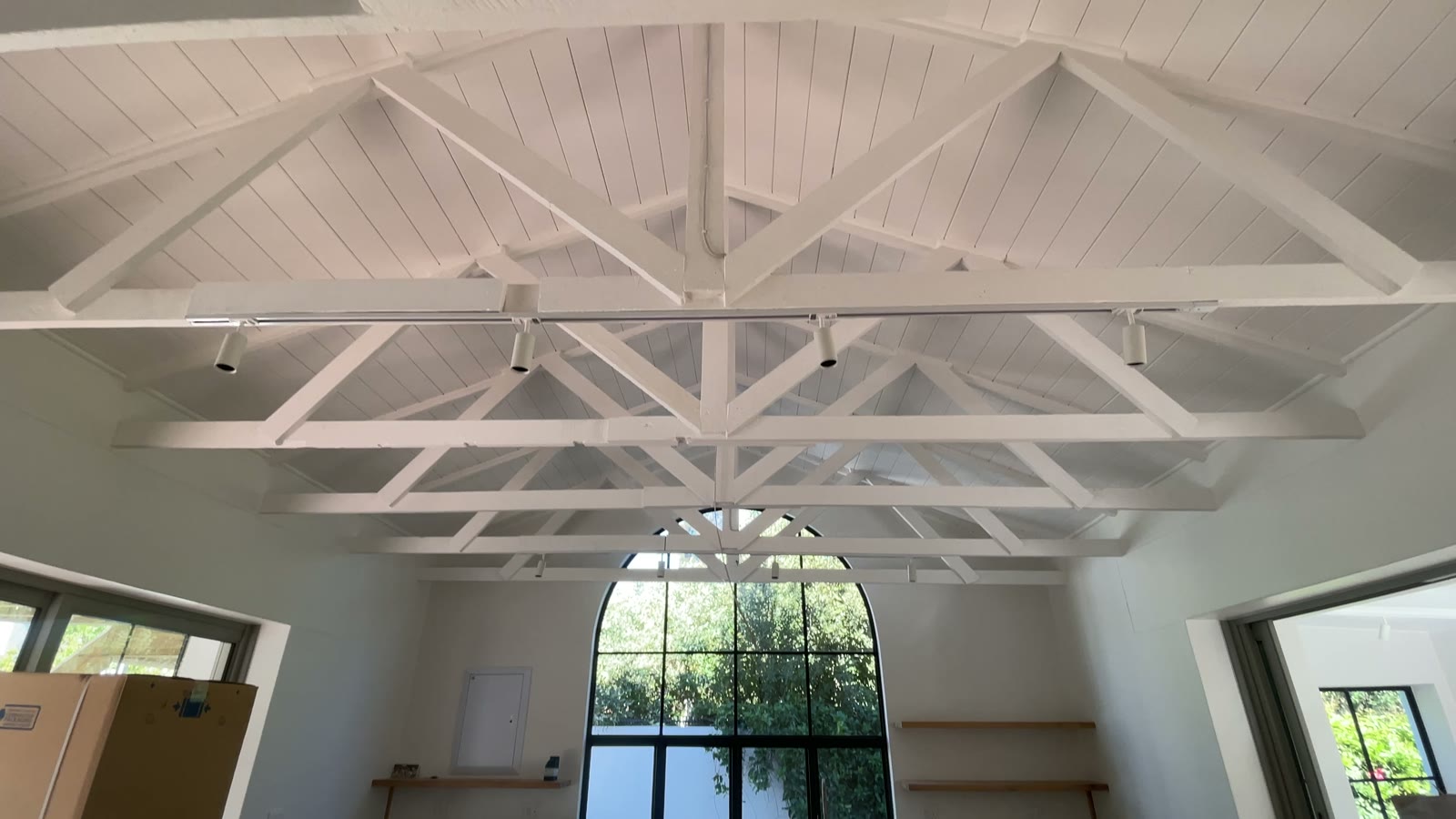 Vaulted timber-truss ceiling above a renovated kitchen