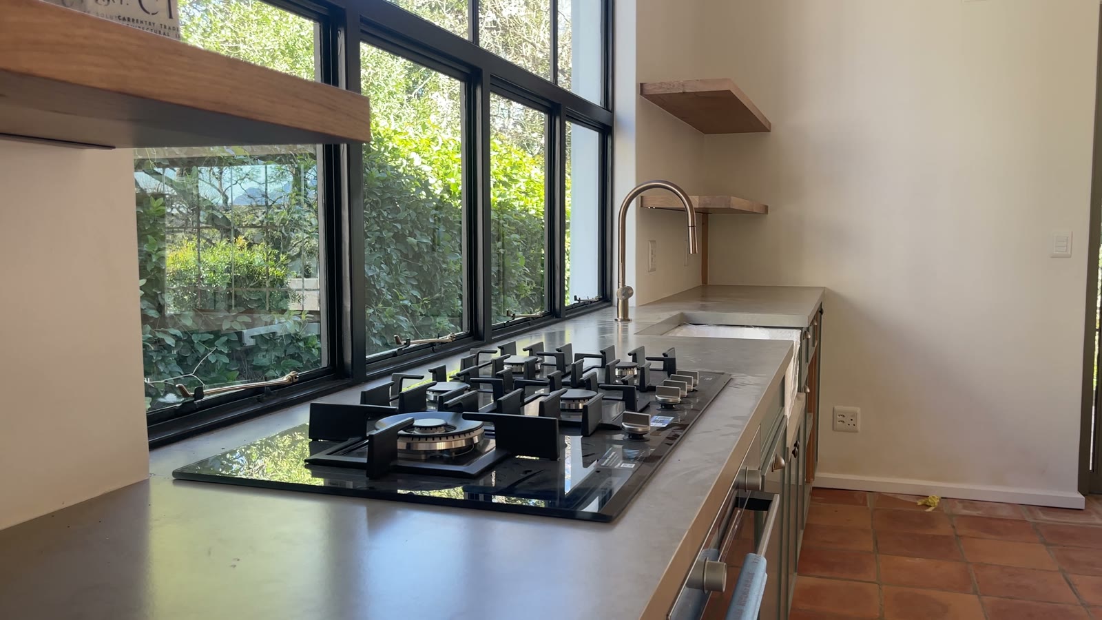 Kitchen worktop with gas hob and steel window