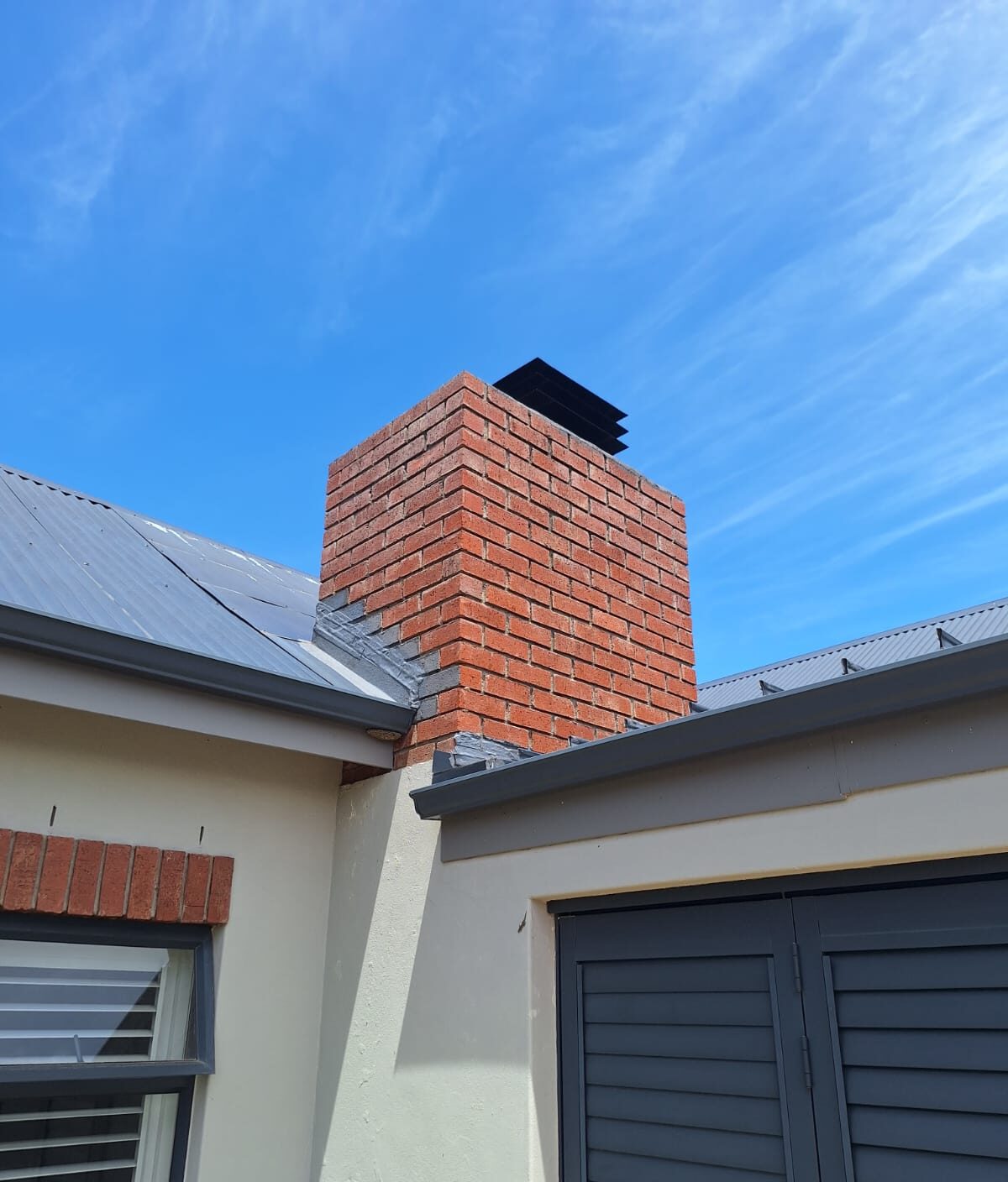 New metal roof and brick chimney
