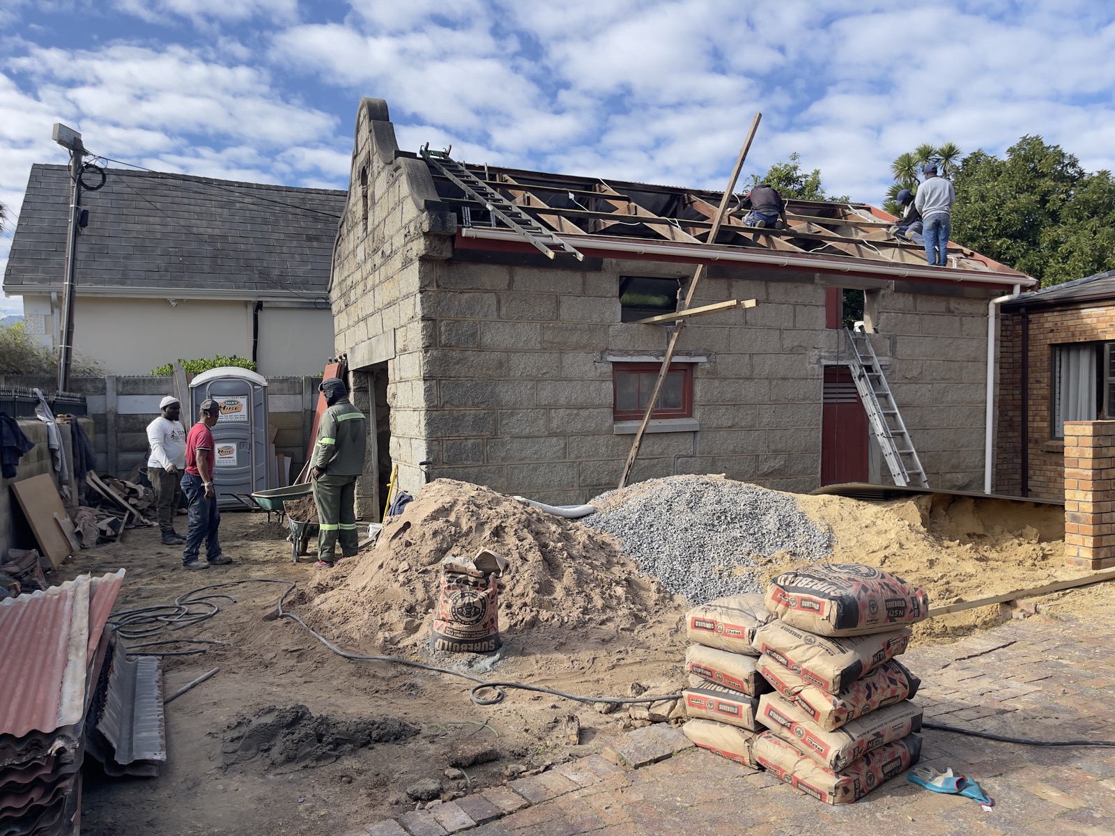 Roof conversion in progress on a heritage stone cottage in the Winelands — crew rebuilding the roof structure