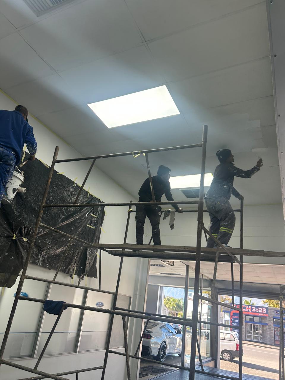 Painters on scaffolding